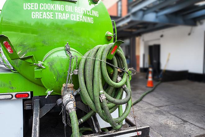 heavy-duty vacuum truck pumping out a grease trap in Belleville